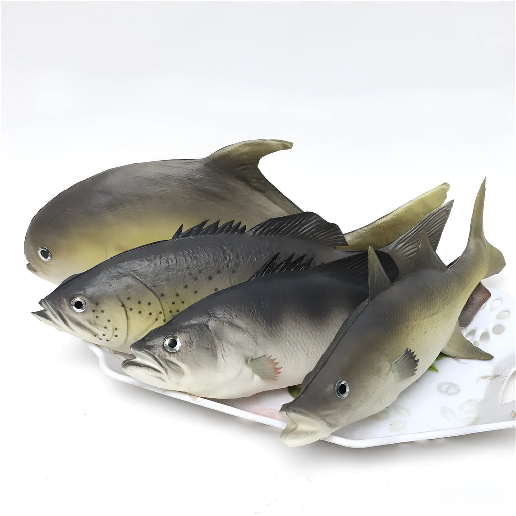 Detailed PU simulated fish ornament in yellow-fin tuna colour on a plain background.