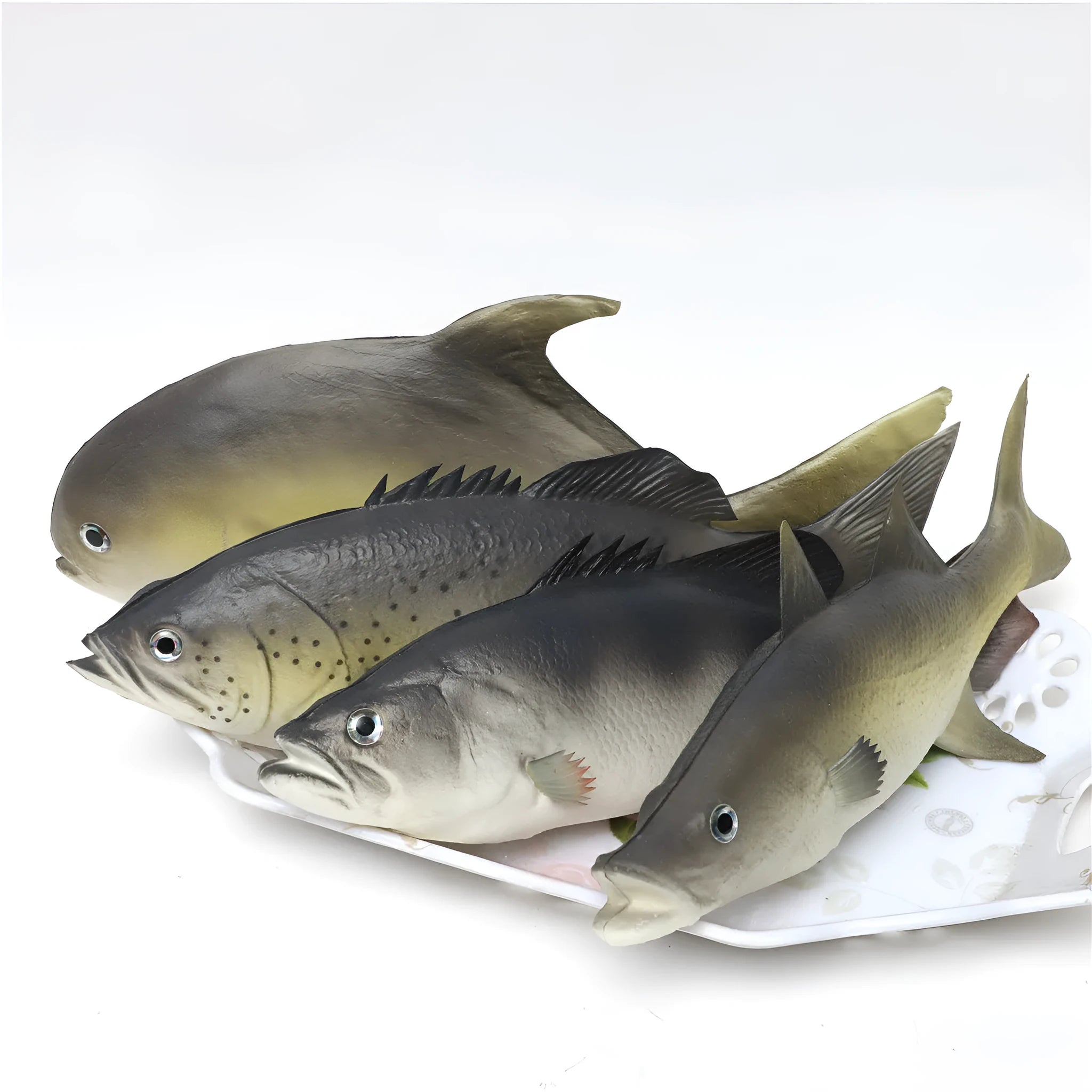 Detailed PU simulated fish ornament in yellow-fin tuna colour on a plain background.