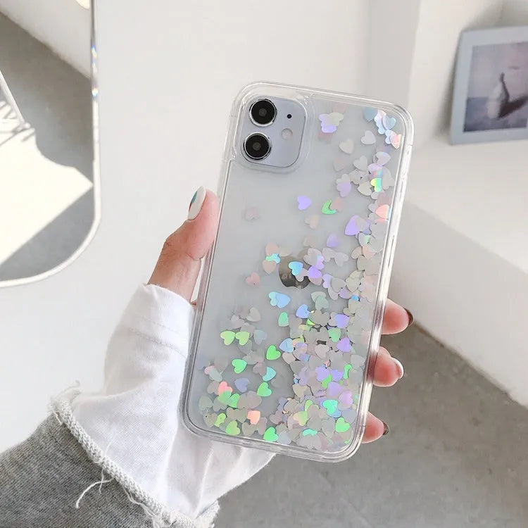 Quicksand flowing love heart silicone phone case in transparent soft TPU bumper for iPhone, available in pink red silver.