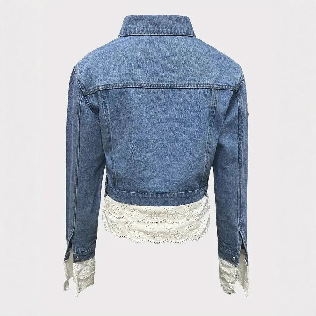 Blue women's denim jacket with white lace stitching detail on the front and sleeves.