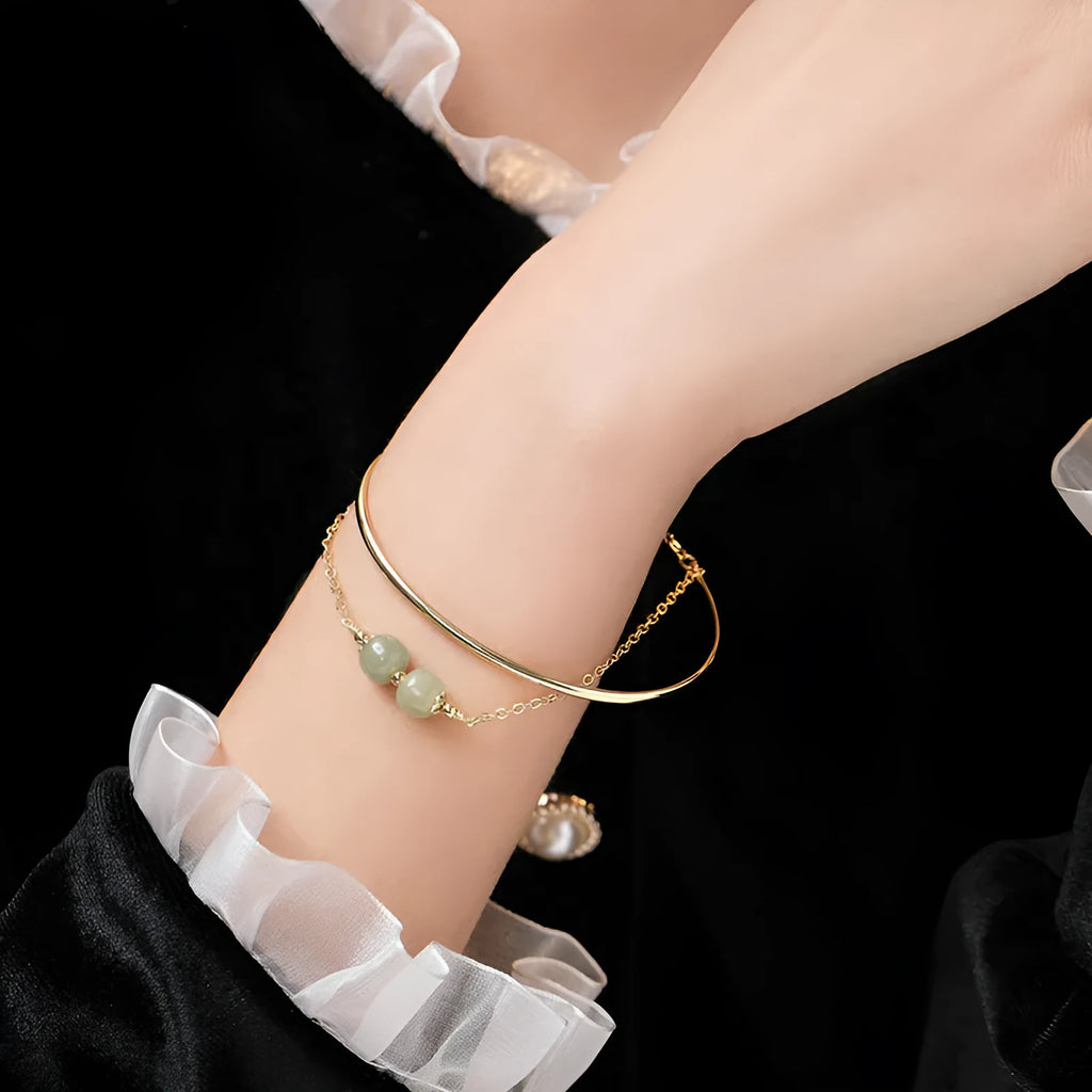 Women's Hetian jade bracelet with gold inlay design in single, double, or three-bead versions.