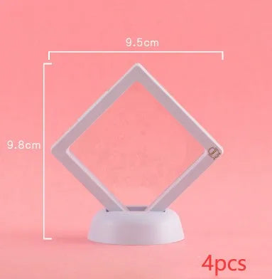3D floating display case holding a coin suspended between transparent membrane sheets, black frame