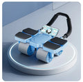 Black automatic rebound abdominal wheel with four blue polyurethane rollers and ergonomic handles on a wooden floor.