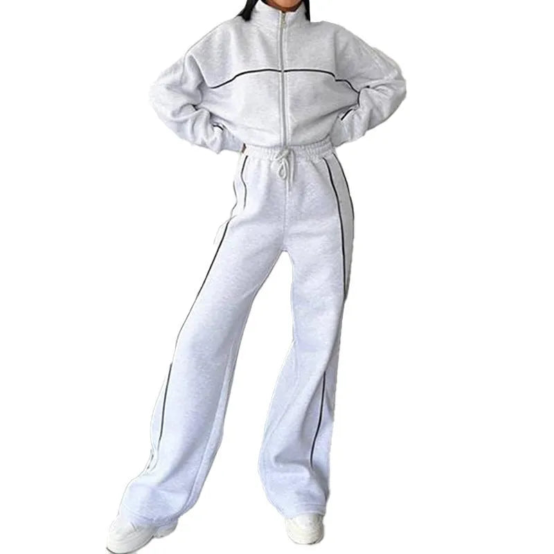 Casual polyester suit set showing a long sleeve mock neck hoodie and striped trousers on a model.