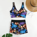 Two-piece female swimsuit with printed boxer briefs and sleeveless top in a multi-colour pattern.