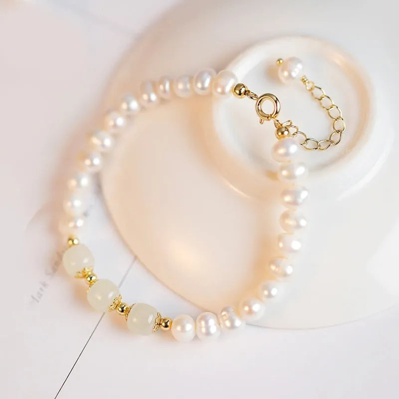 Korean style diamond-shaped freshwater pearl bracelet in Hetian jade colour on a white background.