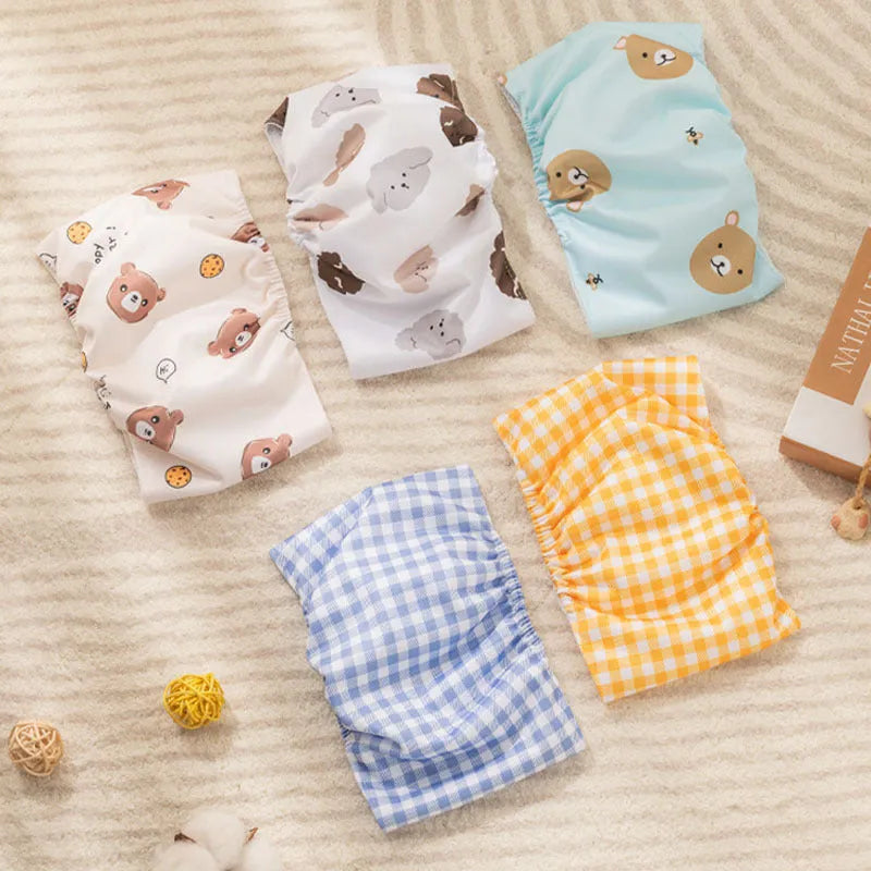 Reusable male dog diaper belly band with cartoon bone paw print design and fastener tape.