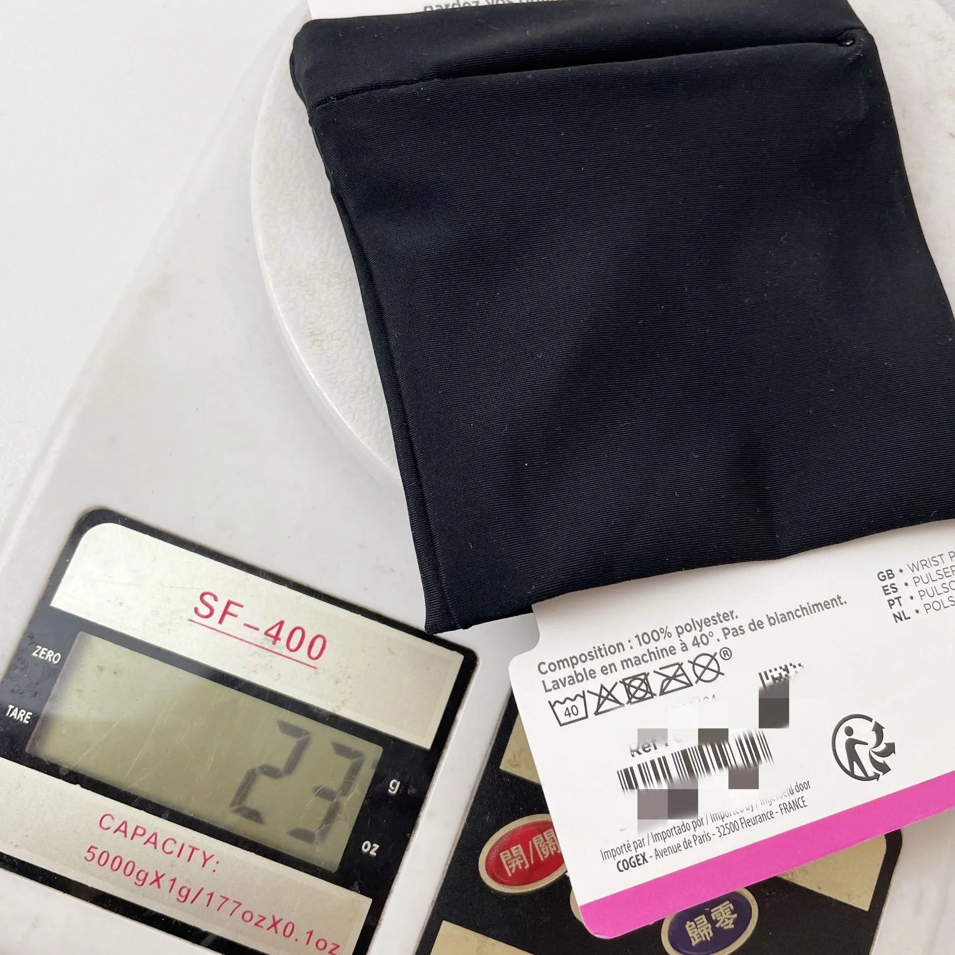 Compact black wrist bag armband sleeve for phone, shown with OPP packaging, dimensions 10cm by 10.5cm.