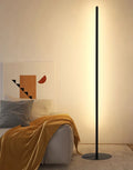 Slender vertical aluminium alloy LED floor lamp in a modern design next to a sofa.