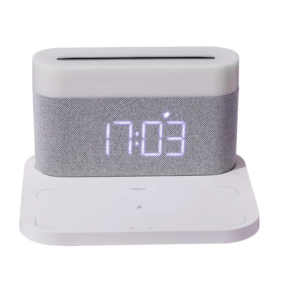 White wireless charging bedside lamp with digital alarm clock display on nightstand