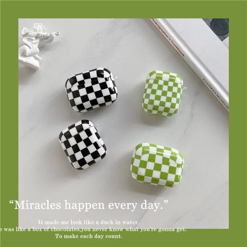Black and green checkerboard pattern TPU protective case sleeves for Apple AirPods, one with a smiley face lanyard attached.