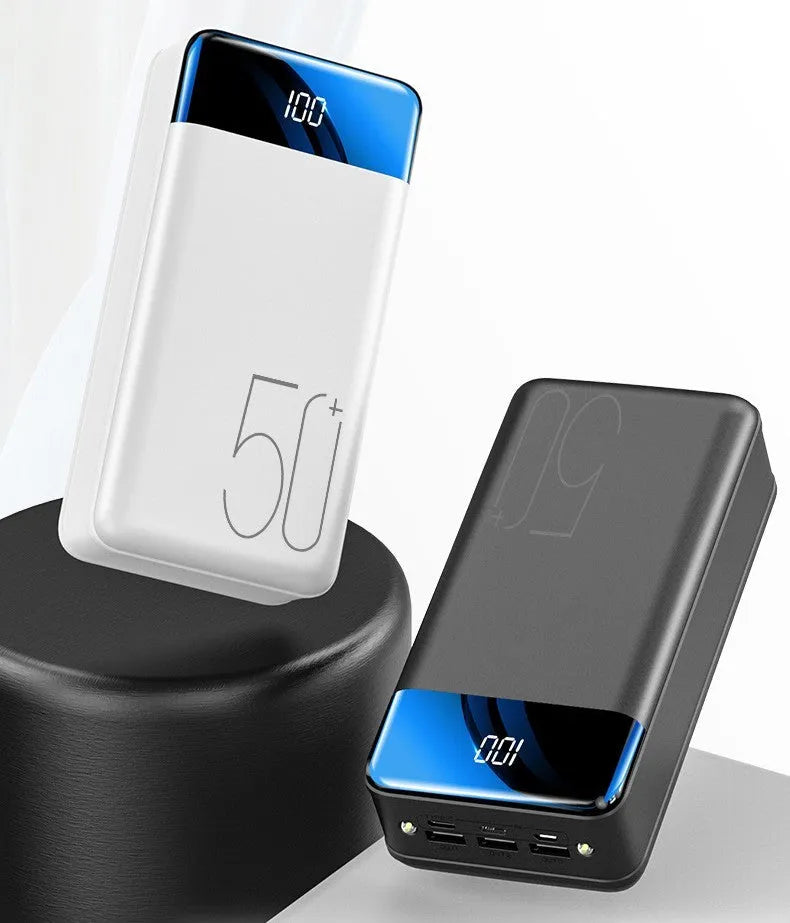Black and white large 50000mAh power bank with three USB output ports on a plain background.