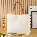 Beige white canvas tote bag with detachable crossbody strap, side bottle pockets, and a front zipped compartment.