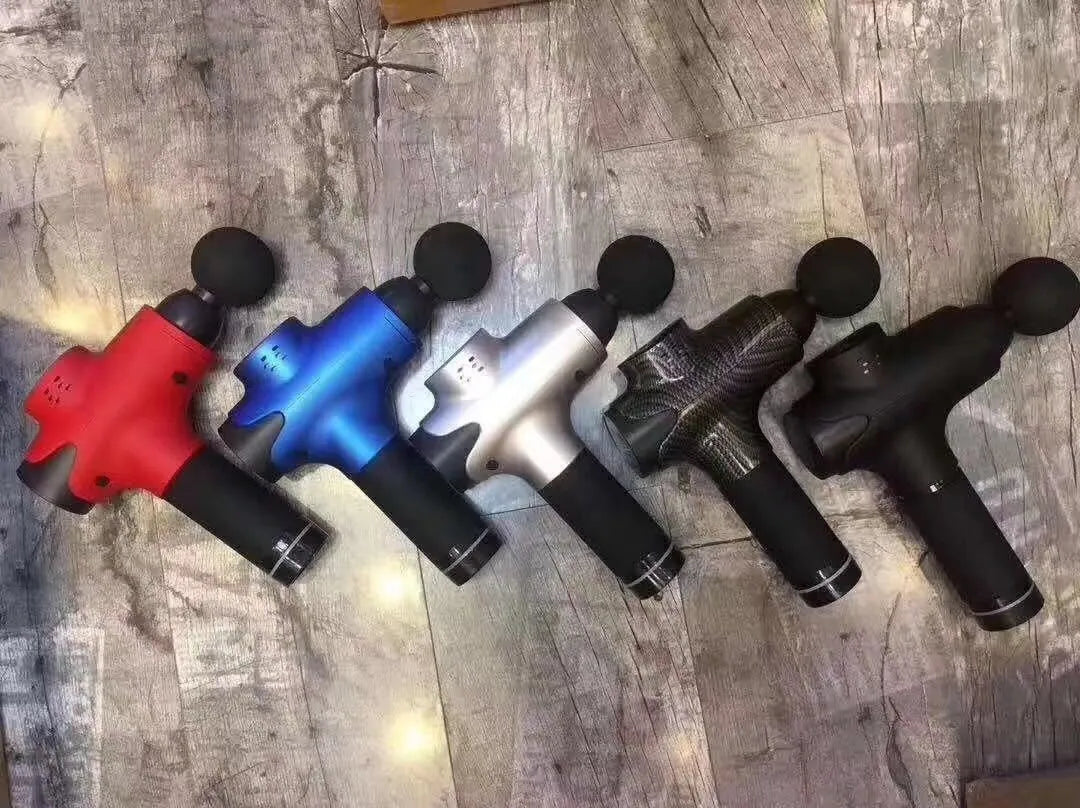 Massage gun with 6 massage heads, black ABS body, and LCD touch screen on a white background