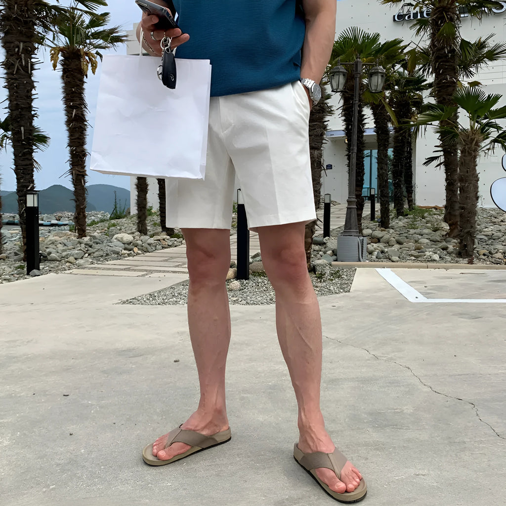 Men's straight-leg casual shorts in solid black, shown laid flat, featuring a non-iron polyester fabric.