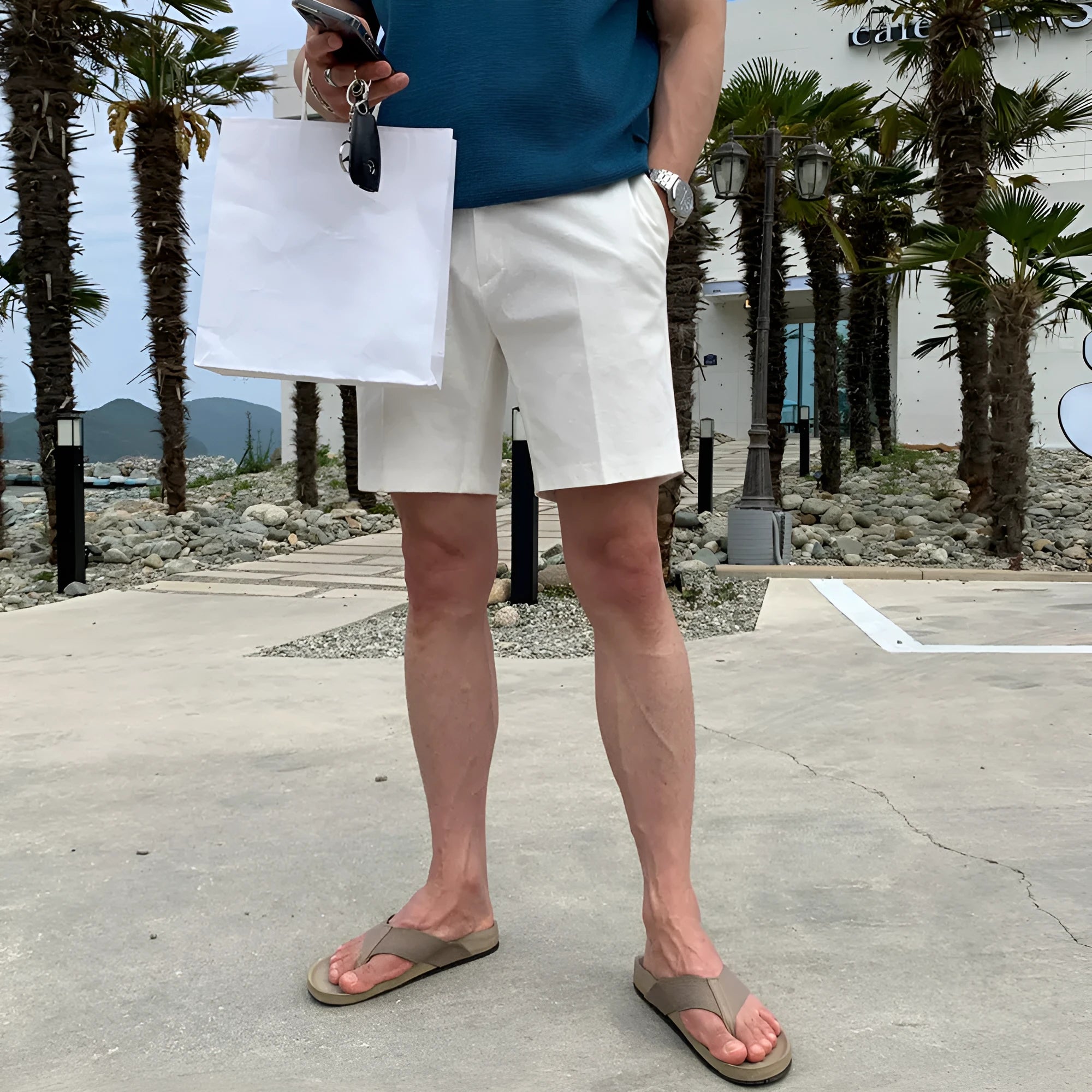 Men's straight-leg casual shorts in solid black, shown laid flat, featuring a non-iron polyester fabric.