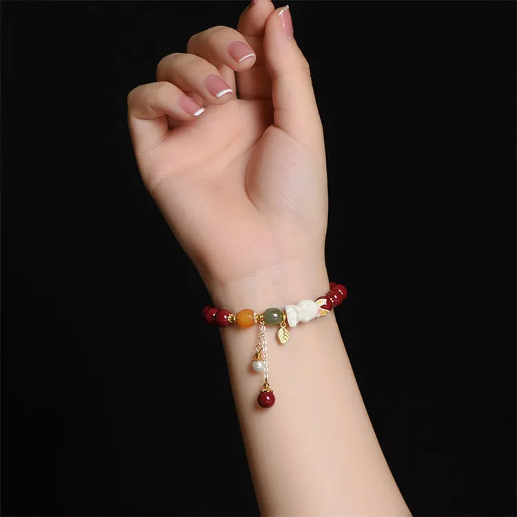 Tian Yu natural cinnabar bracelet with rabbit design in 8mm or 10mm sizes
