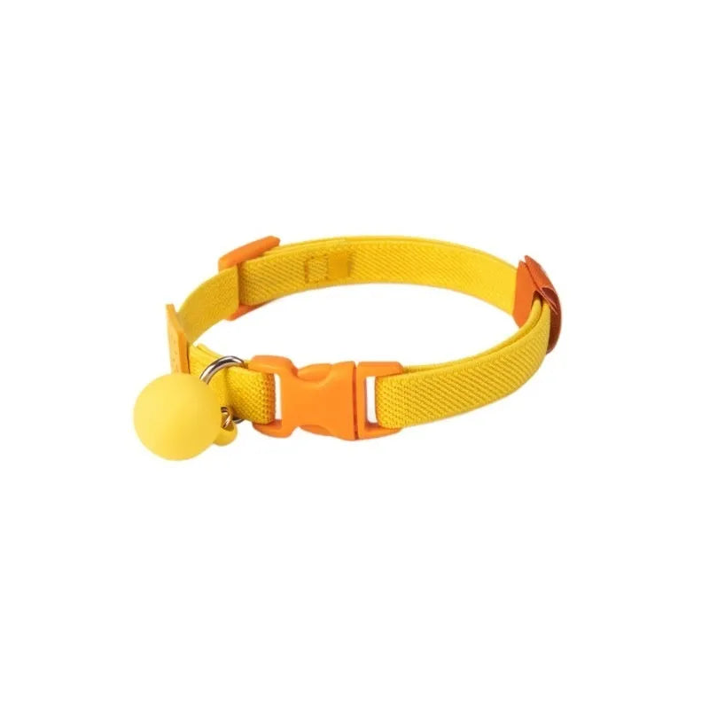 Small elastic dog collar in dark blue, stretched to show flexibility on a measuring tape from 22 to 32 cm.