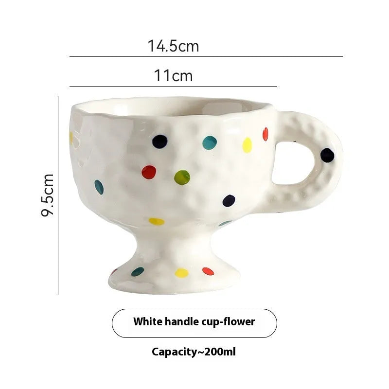 Hand-pinched irregular shaped ceramic mug in a solid colour on a plain background.