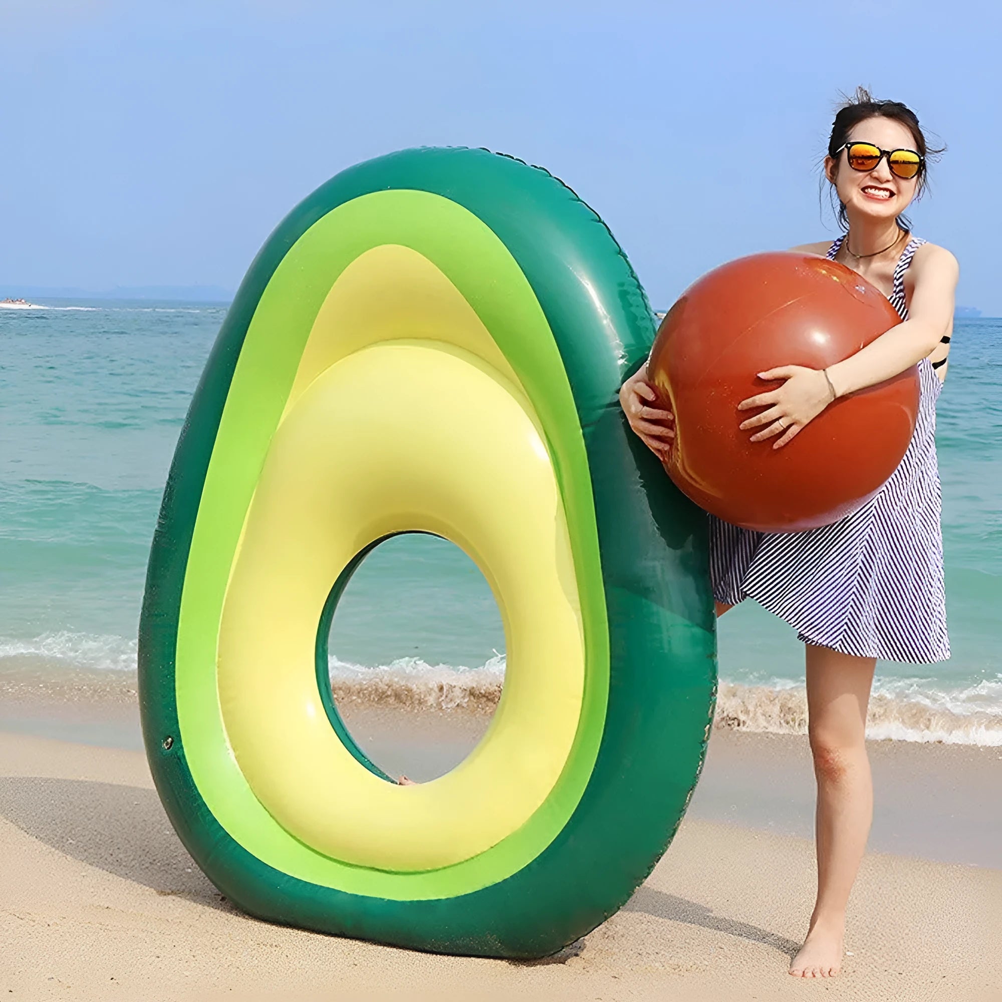 Giant green avocado-shaped inflatable pool float measuring 169cm by 130cm.