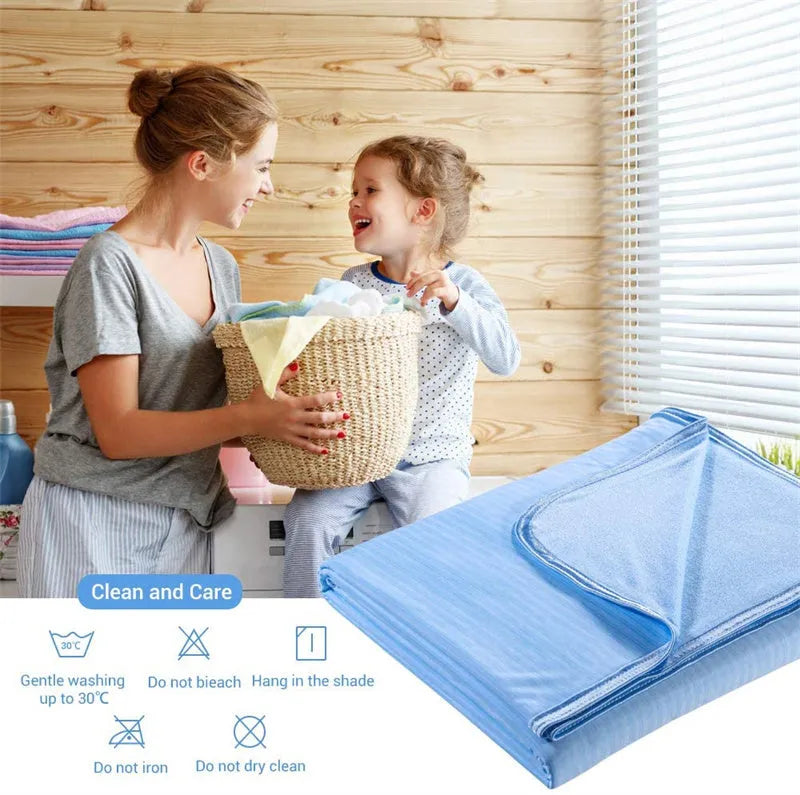 Cooling blanket in blue, grey, and pink colours on a bed, showing the polyester weave and Q-Max cooling fiber technology