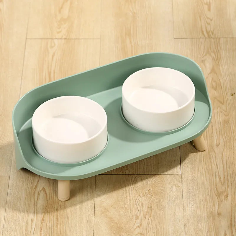 Green and white adjustable tilted pet feeding bowl with dual food and water compartments for cats and dogs