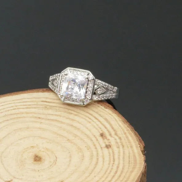 Women's platinum colour geometric zircon ring with hollow quadrilateral design on a copper band.
