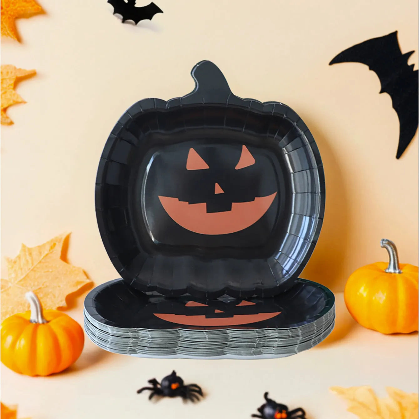 Black Halloween disposable paper plates with pumpkin designs, 9-inch diameter