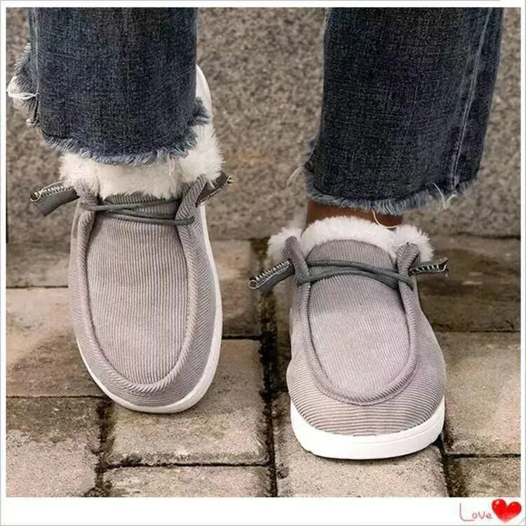 Women's winter snow boots with cotton upper and plush lining in grey, side view showing front-tie lacing and ankle height