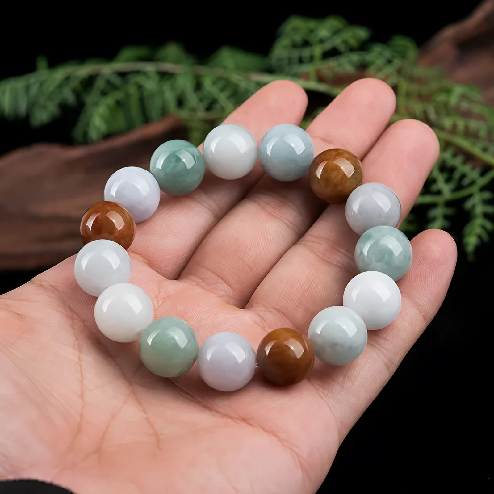 Women's bracelet with round three-colour jade beads, certificate visible.