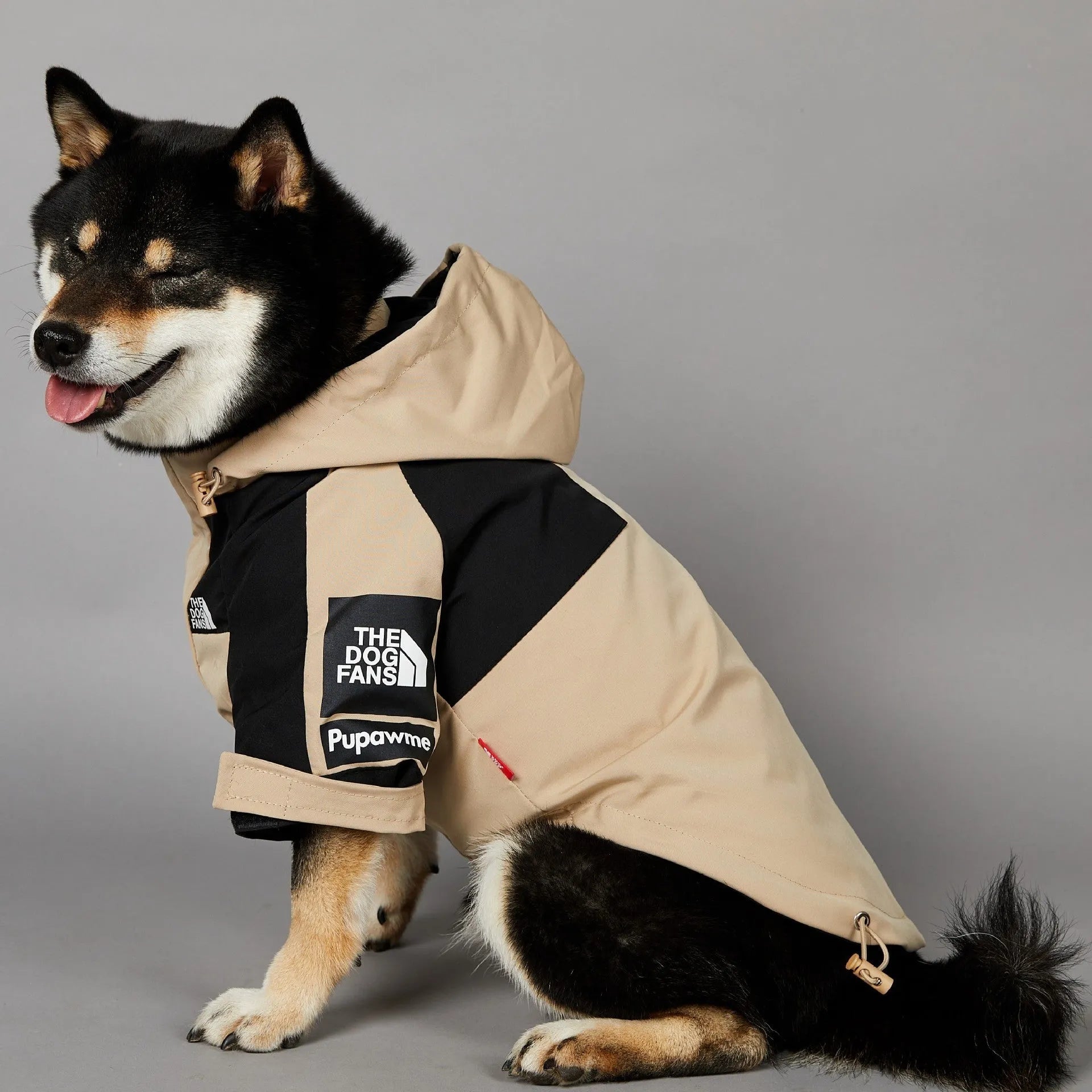Khaki coloured polyester shell jacket for a dog, shown on a mannequin.
