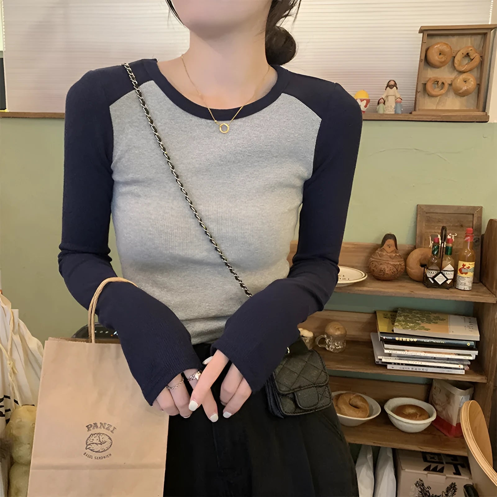 Dark blue oversized ladies top with long princess sleeves and a short hem.