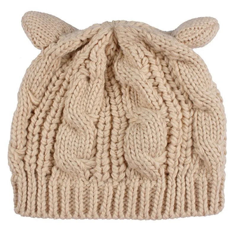 Red hand-knitted wool beanie hat with 3D cat ears on a white background.
