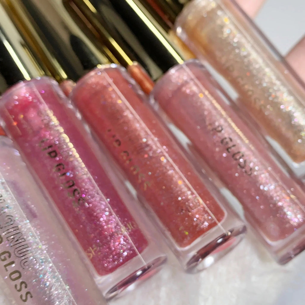 Moisturising lip gloss tube showing reflective finish in choice of five colours: pink, gold, peach, purple, and red.