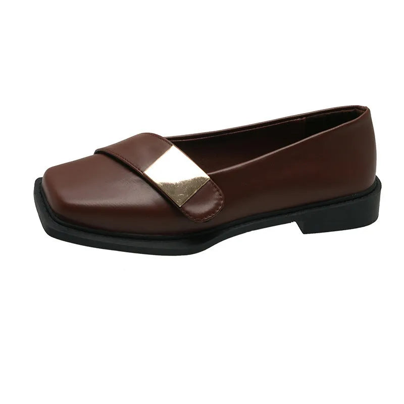 Beige women's square-toe flat shoes with a metal buckle and low rubber sole.