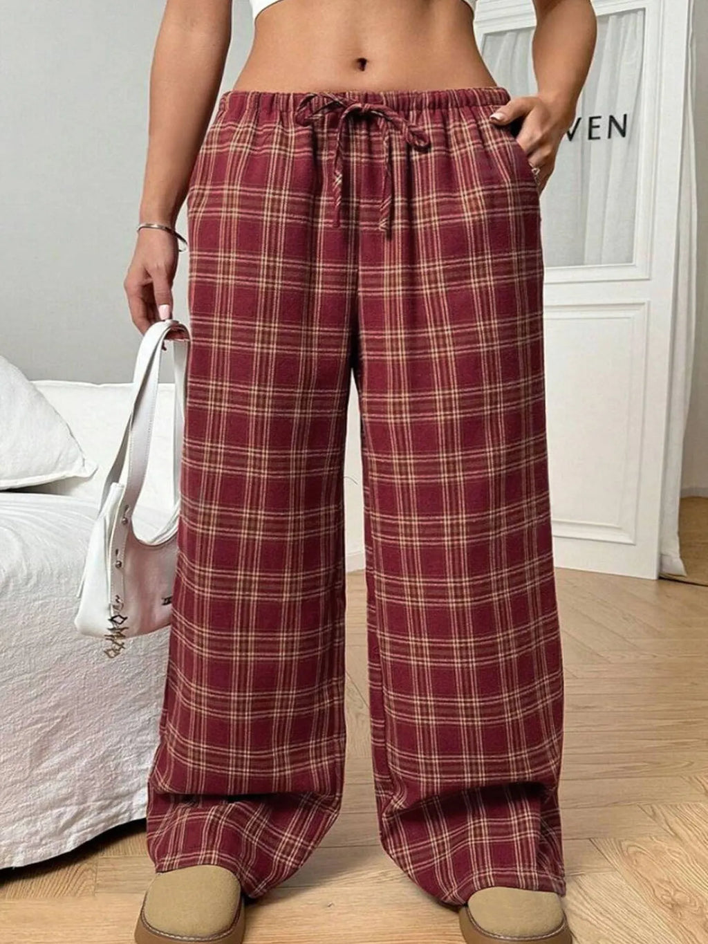 Women's red casual loose trousers with drawstring waist and plaid pockets on mannequin