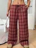 Women's red casual loose trousers with drawstring waist and plaid pockets on mannequin