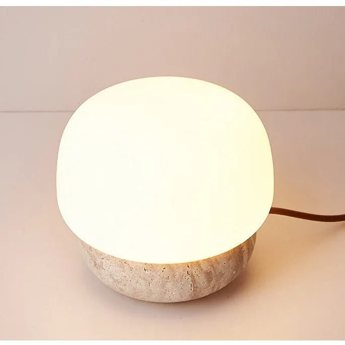 Cream-coloured retro glass bedside lamp with a button switch on its base.