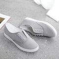 Low-top canvas casual shoes in black, shown on a flat heel with a breathable canvas upper.