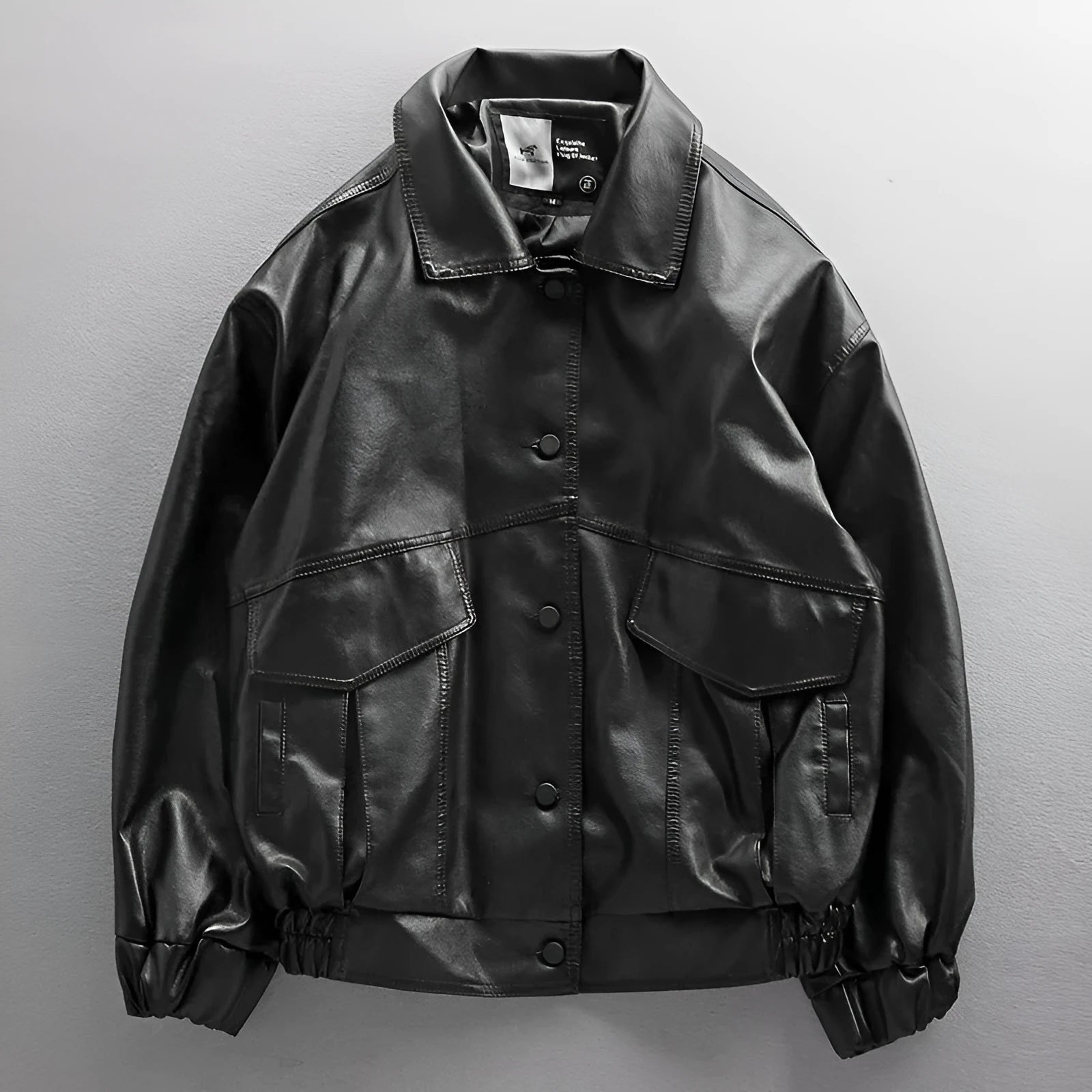 Men's black PU leather biker jacket with loose fit and zip front, available in sizes M to XXL