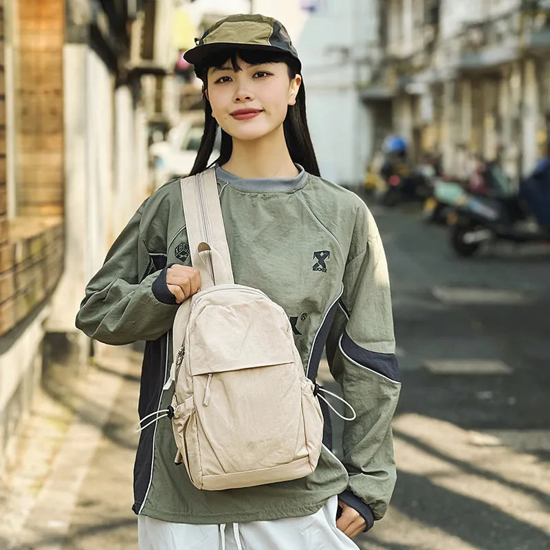 Waterproof nylon backpack in black, green, grey, or white, free size, crossbody or chest bag for outdoor travel.