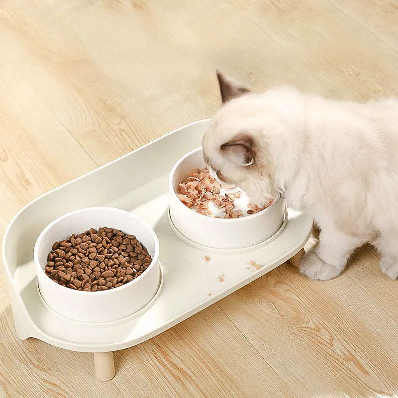 Green and white adjustable tilted pet feeding bowl with dual food and water compartments for cats and dogs