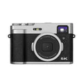 Black 5K digital camera with dual lenses and optical viewfinder on display screen