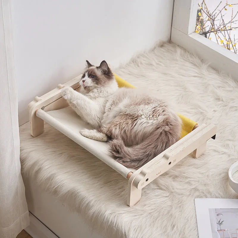 Solid wood cat bed with removable cushion in grey-toned seasonal pattern colours