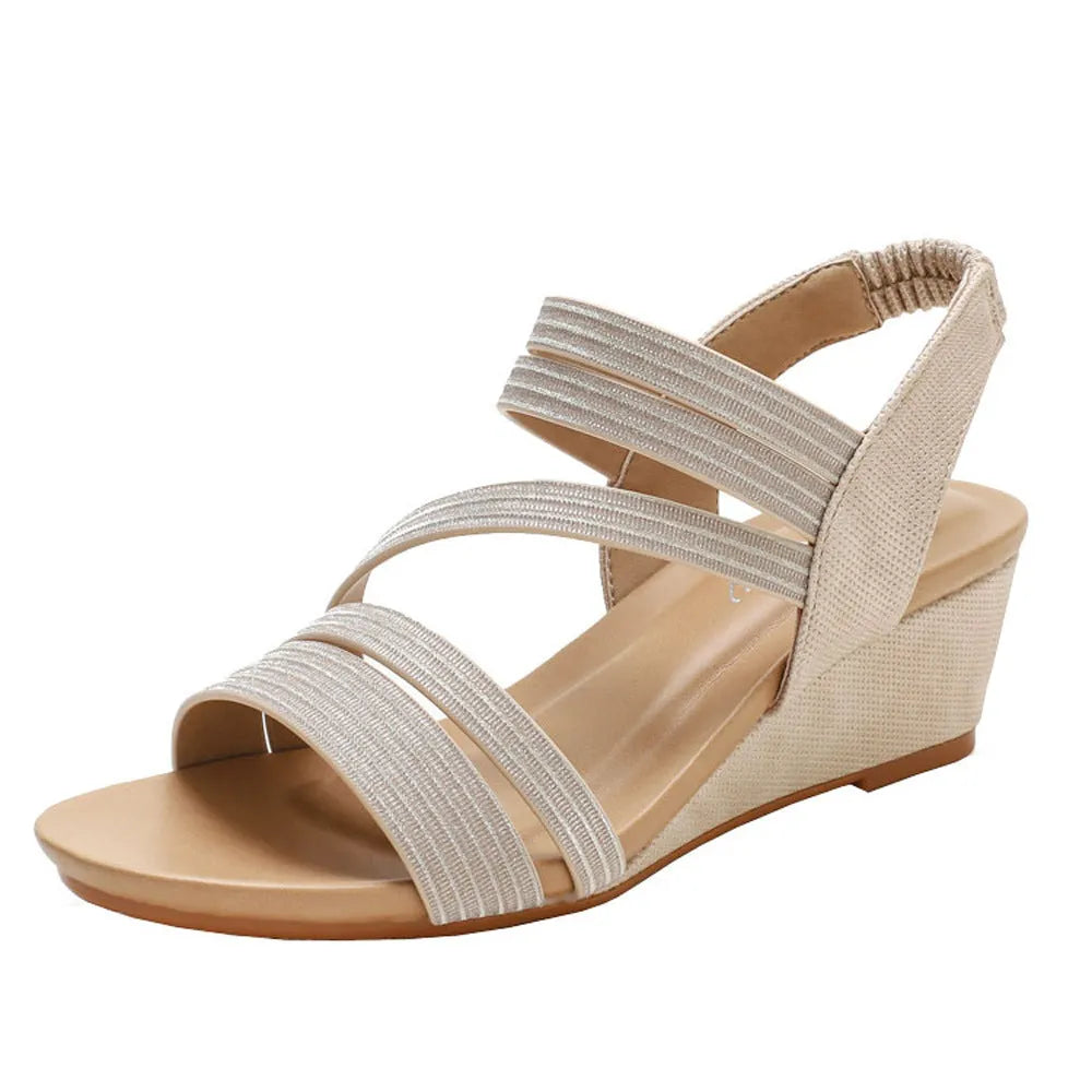 Women's gold platform sandals with a mid-heel on a white background