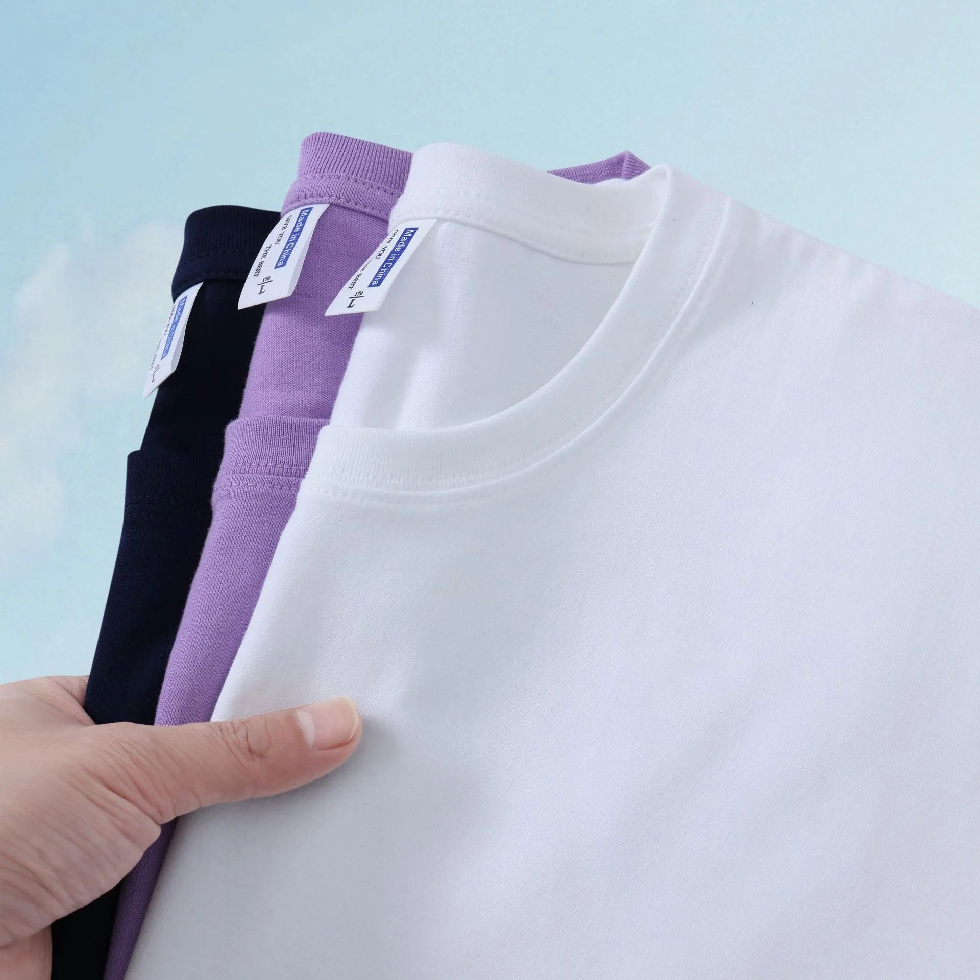A loose-fit, thick cotton T-shirt in a solid colour, shown on a hanger.
