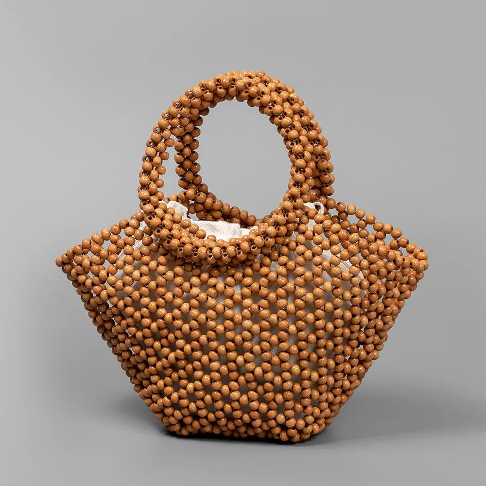 Hand-woven dumpling-shaped maple beach handbag with wooden bead decoration in milky white colour