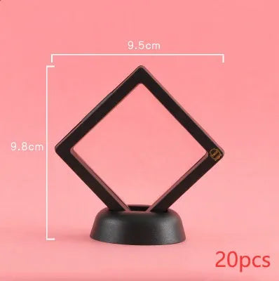 3D floating display case holding a coin suspended between transparent membrane sheets, black frame