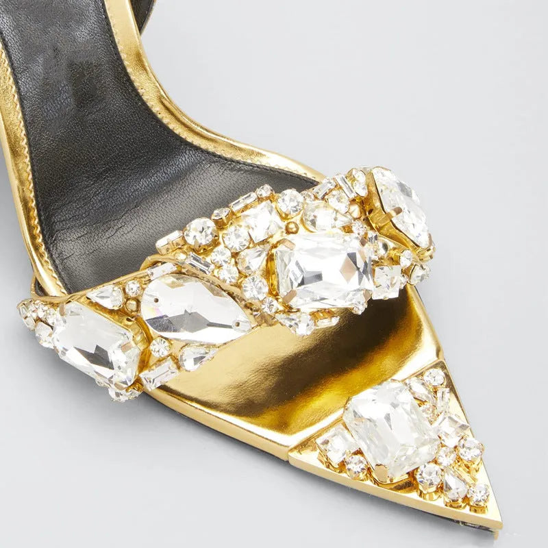 Super high heel pointed toe rhinestone slingback heels in gold on display