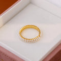 Gold electroplated open mouth pearl ring with geometry design on a copper base.